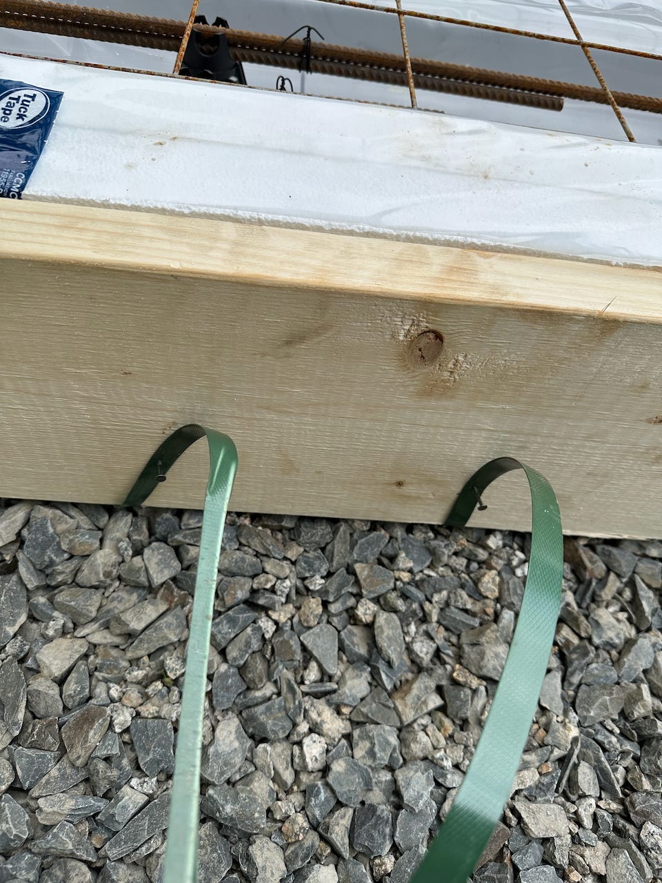 A closeup of the straps used underneath the supports to hold the forms in place.